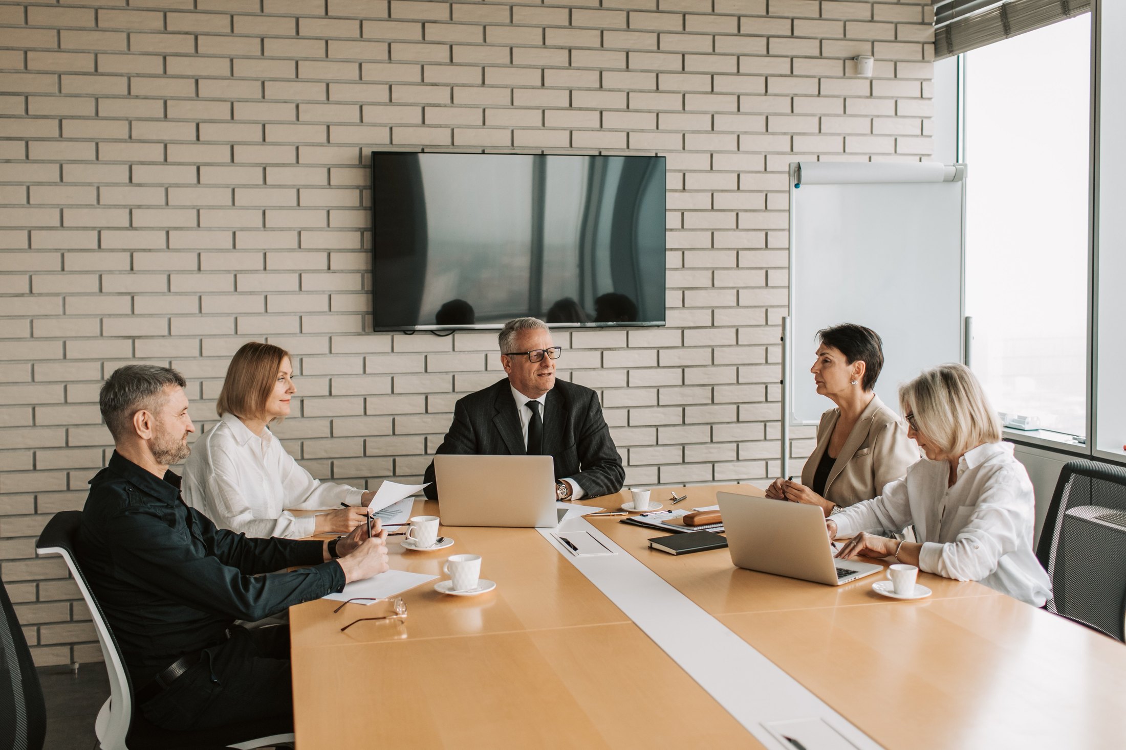 Professional meeting around a conference table during an operations review